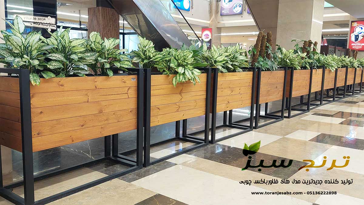 فلاورباکس های چوب ترموود و فریم فلزی مدل شقایق در داخل مجتمع تجاری قدس در شهر مشهد که تولید ترنج سبز هستند.